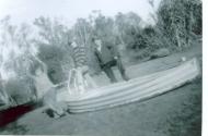 Family members pose with the corrugated iron dinghy during the 1950s.