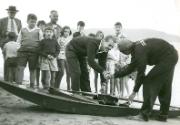 'Jack' O'Brien and  ST CHRIS with a crowd of interested bystanders on the beach, date unknown.