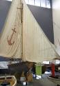 The restored 18-foot skiff YENDYS with its transom bow and an original set of sails, is on disp…