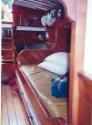 A view aft showing one of the settee berths in the saloon, either side of the centrecase castin…