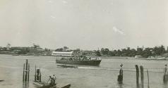 An unknown Fairmile on the Parramatta River off the sheds at Green Point, in the background is …