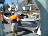 Motor Whaler 2717 being moved aboard HMAS DIAMANTINA in 2010 at the Queensland Maritime Museum